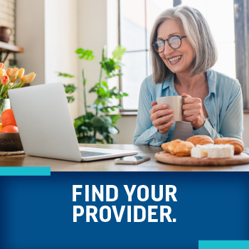 Woman smiling at laptop