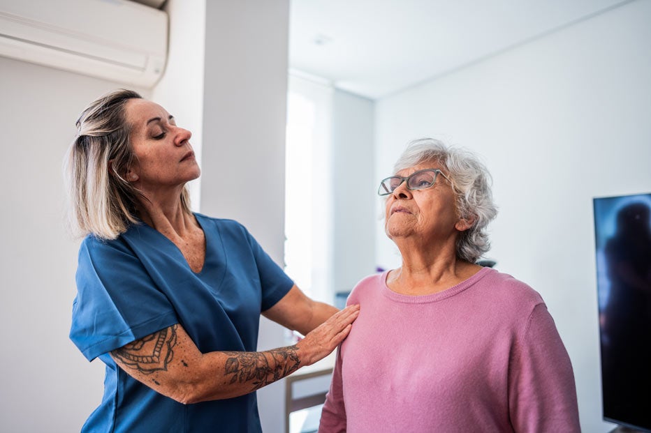 Senior woman breathing with respiratory therapist